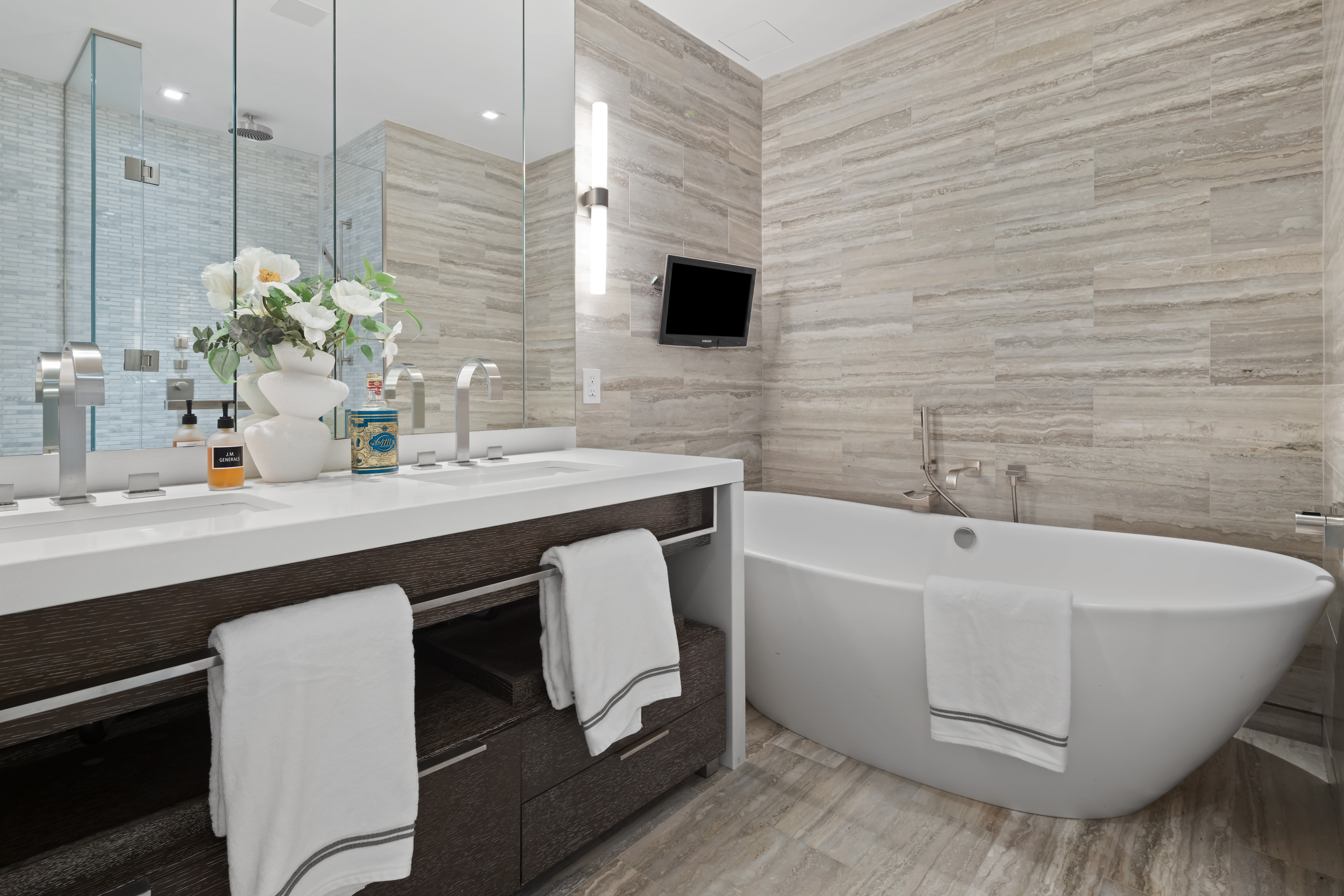 400 West 12th Street, Unit 4E Manhattan, NY 10014 - Photo 15 of 24 a bathroom with a sink a mirror and a bathtub