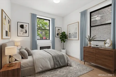 a bedroom with a large bed and a window