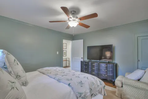 a bedroom with a bed and a chandelier