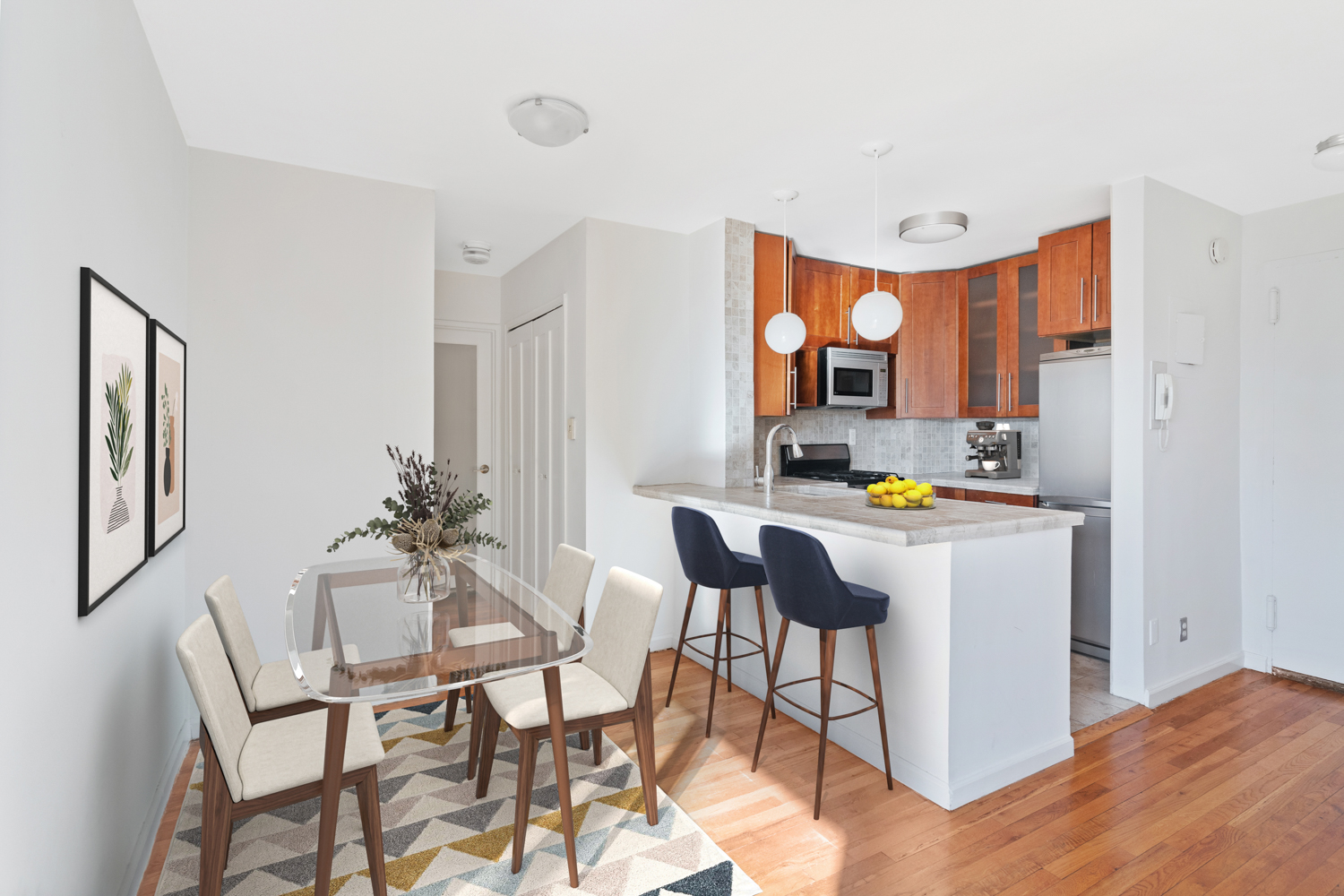 165 Christopher Street, Unit 5CC Manhattan, NY 10014 - Photo 2 of 13 a room with a table chairs and a refrigerator