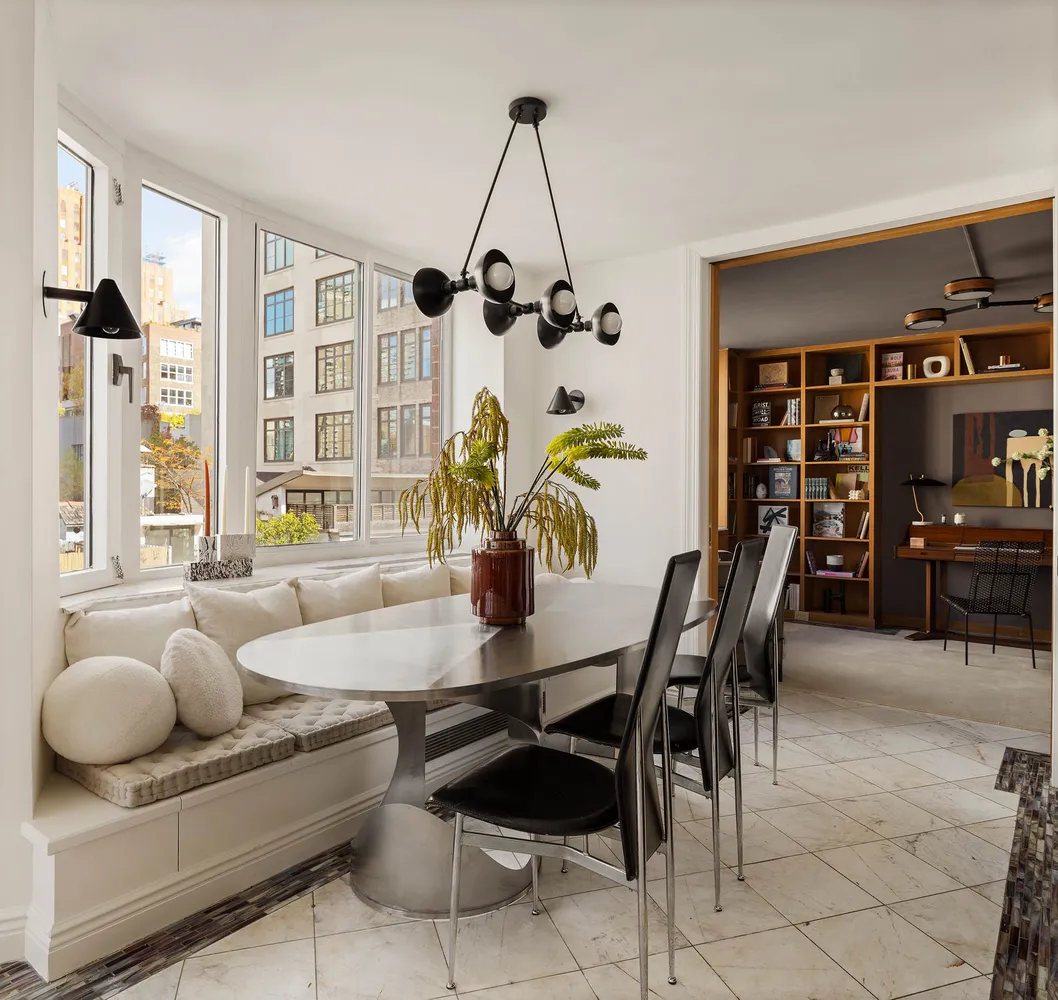 a view of a dining room with furniture and a potted plant
