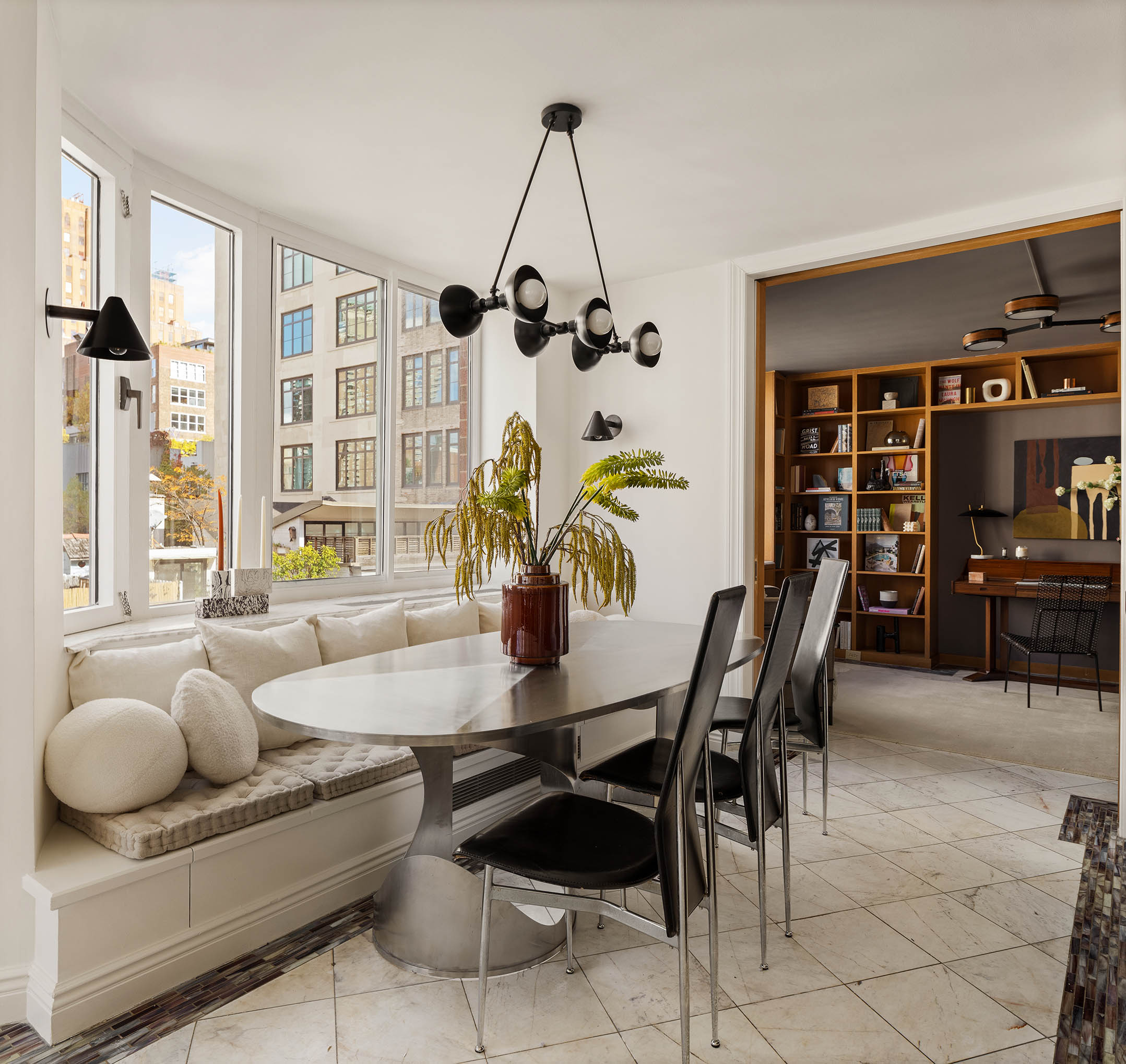 295 Greenwich Street, Unit 8/9H Manhattan, NY 10007 - Photo 6 of 22 a view of a dining room with furniture and a potted plant