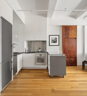 a kitchen with stainless steel appliances a refrigerator sink and cabinets