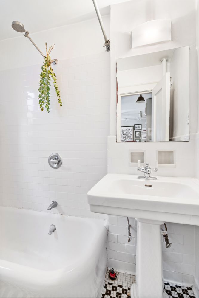 104 Bedford Street, Unit 4C Manhattan, NY 10014 - Photo 7 of 9 a bathroom with a sink a mirror and a bathtub