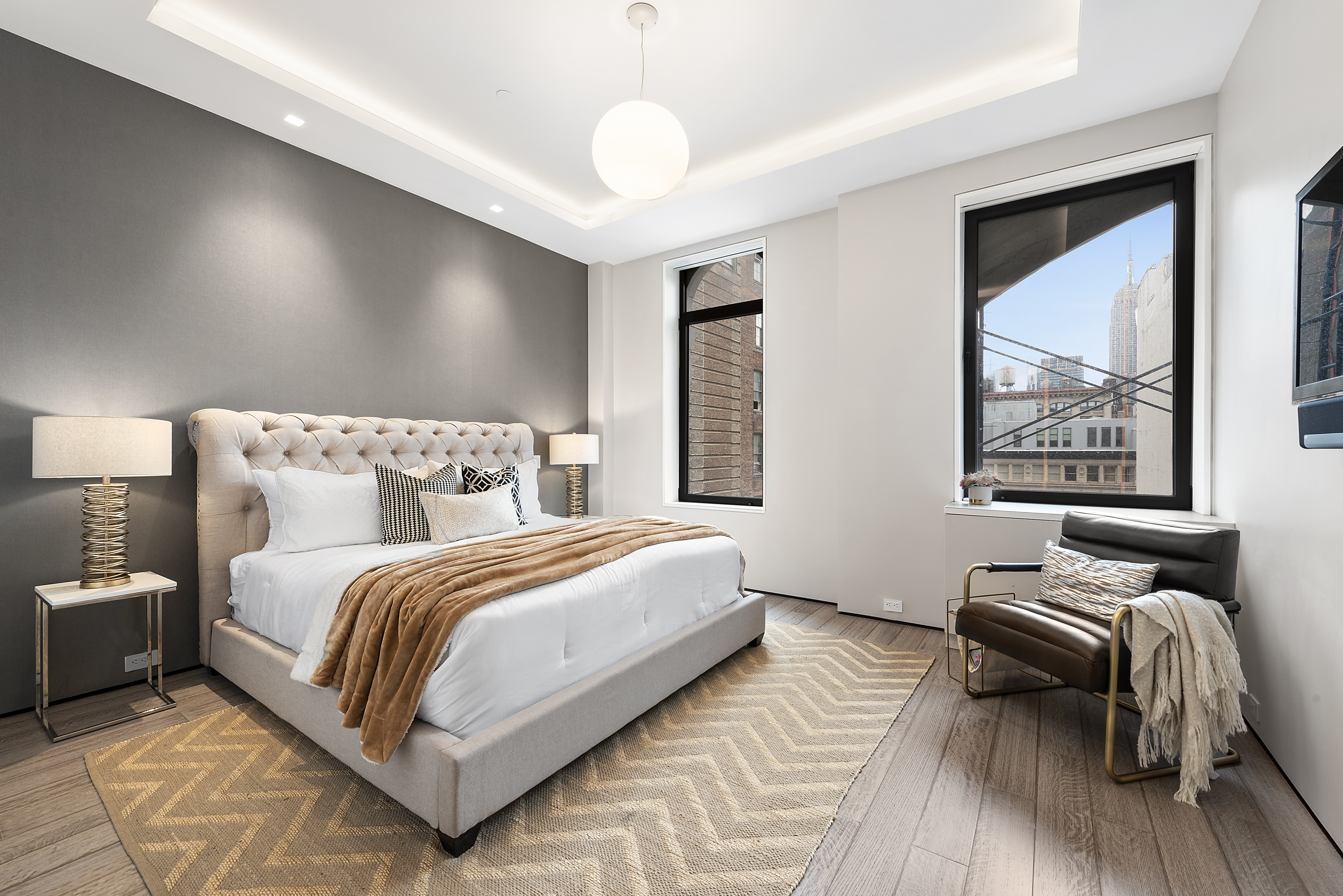 40 West 17th Street, Unit 9A Manhattan, NY 10011 - Photo 7 of 12 a bedroom with bed and a large window