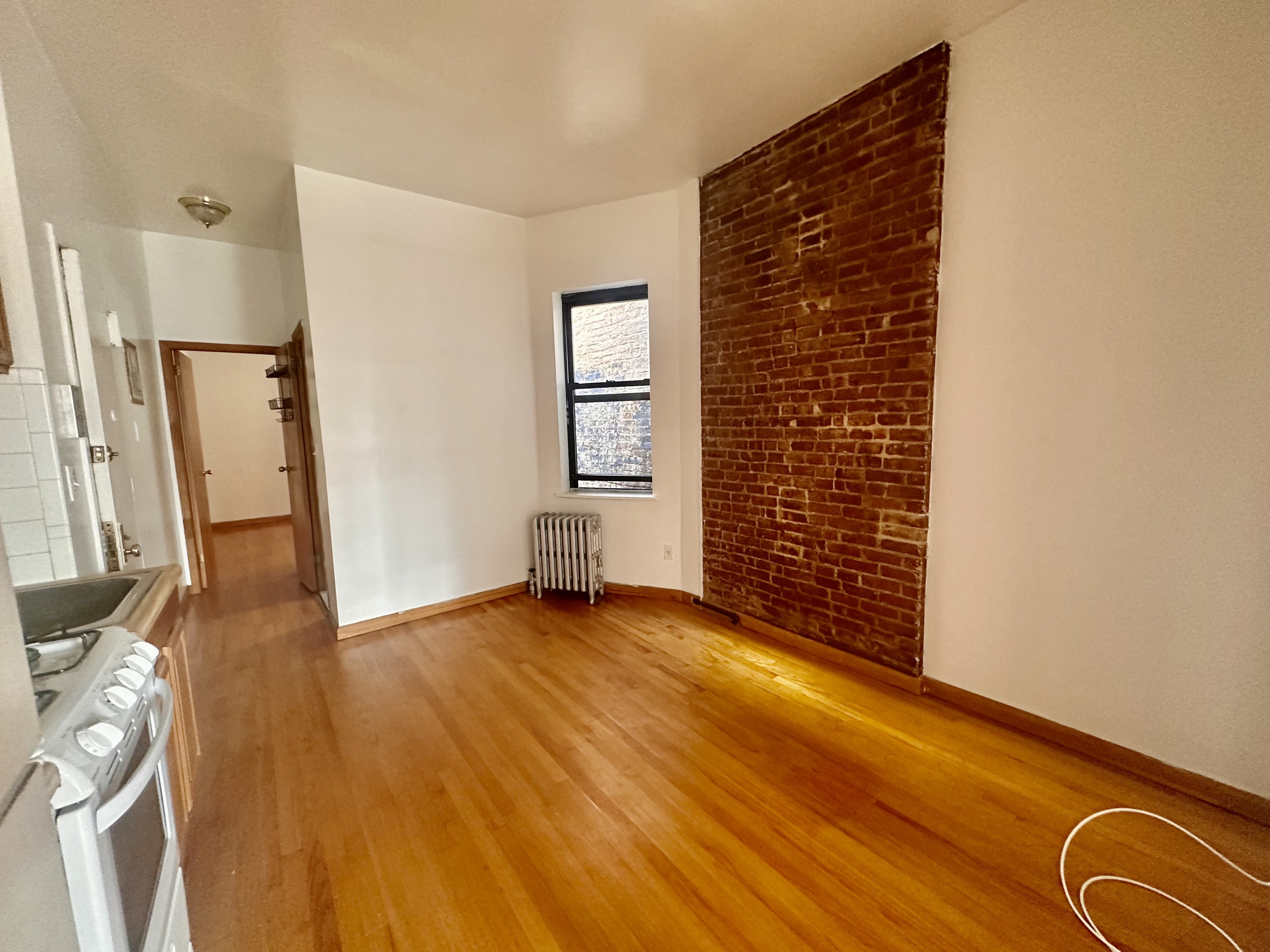 22 St Marks Place, Unit 19 Manhattan, NY 10003 - Photo 2 of 7 an empty room with wooden floor and windows