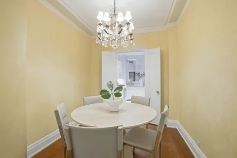 a view of a dining room with a table and chairs