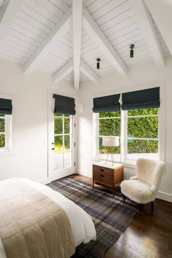 a living room with furniture a flat screen tv and kitchen view