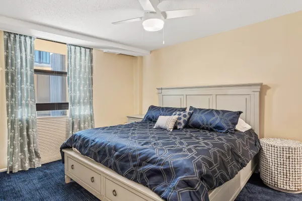 a bedroom with a bed and cabinets