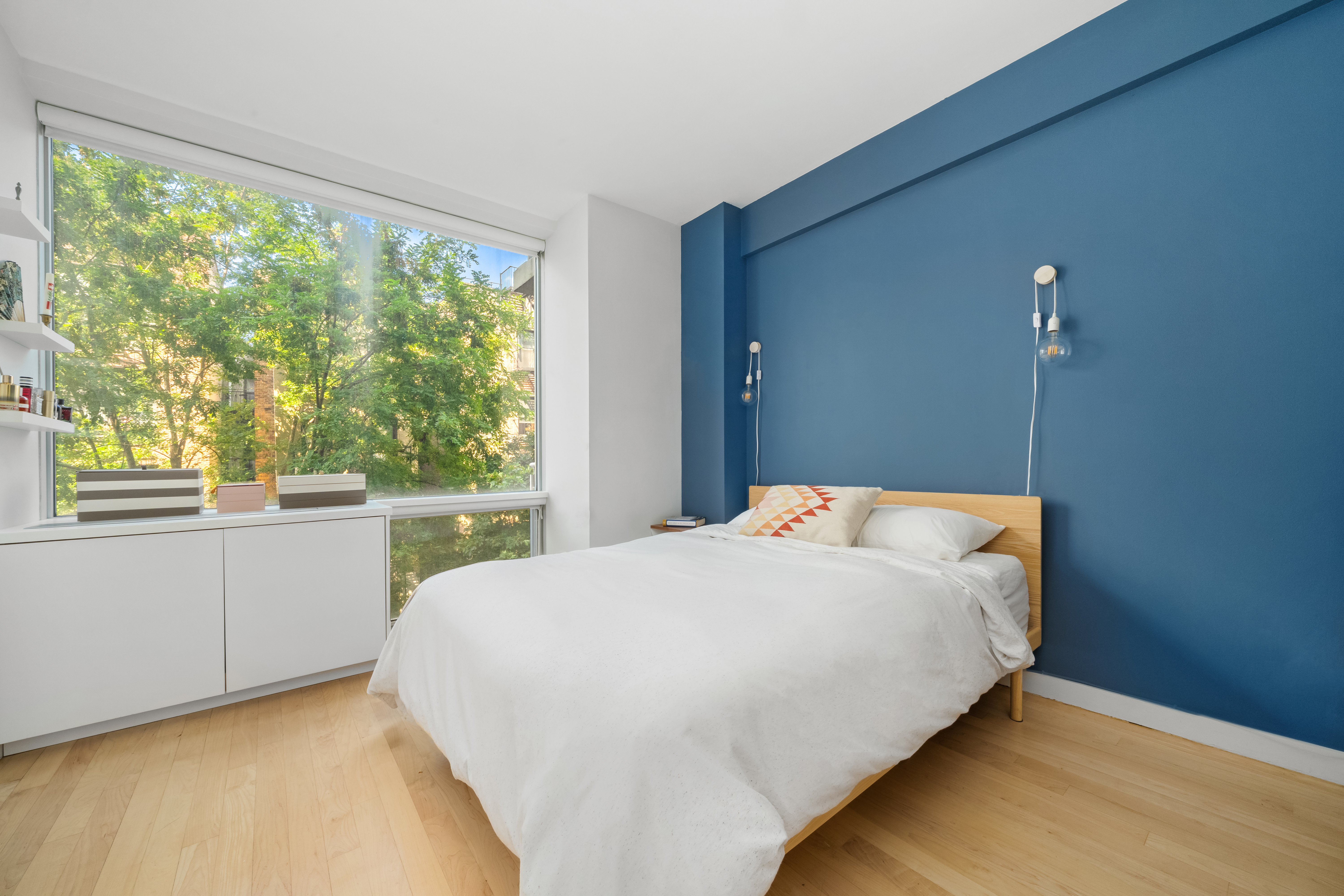 425 East 13th Street, Unit 4C Manhattan, NY 10009 - Photo 6 of 14 a bedroom with a bed and a large window