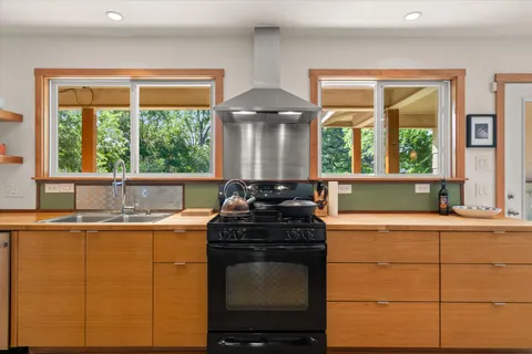 a kitchen with granite countertop a stove and a sink