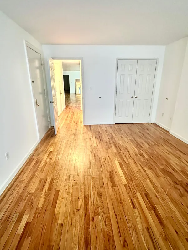 a view of a room with wooden floor