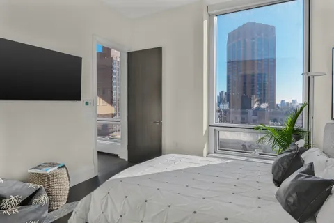 a bedroom with a bed and a television