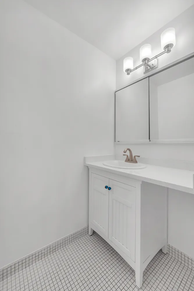 a bathroom with a sink a vanity and a mirror