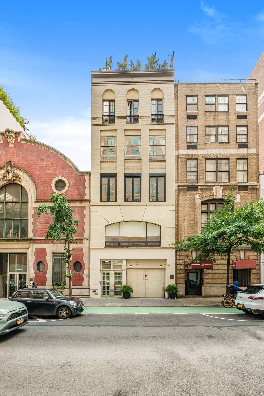 124 East 13th Street, Unit 3 Manhattan, NY 10003 - Photo 2 of 26 a front view of a building with lot of cars and trees