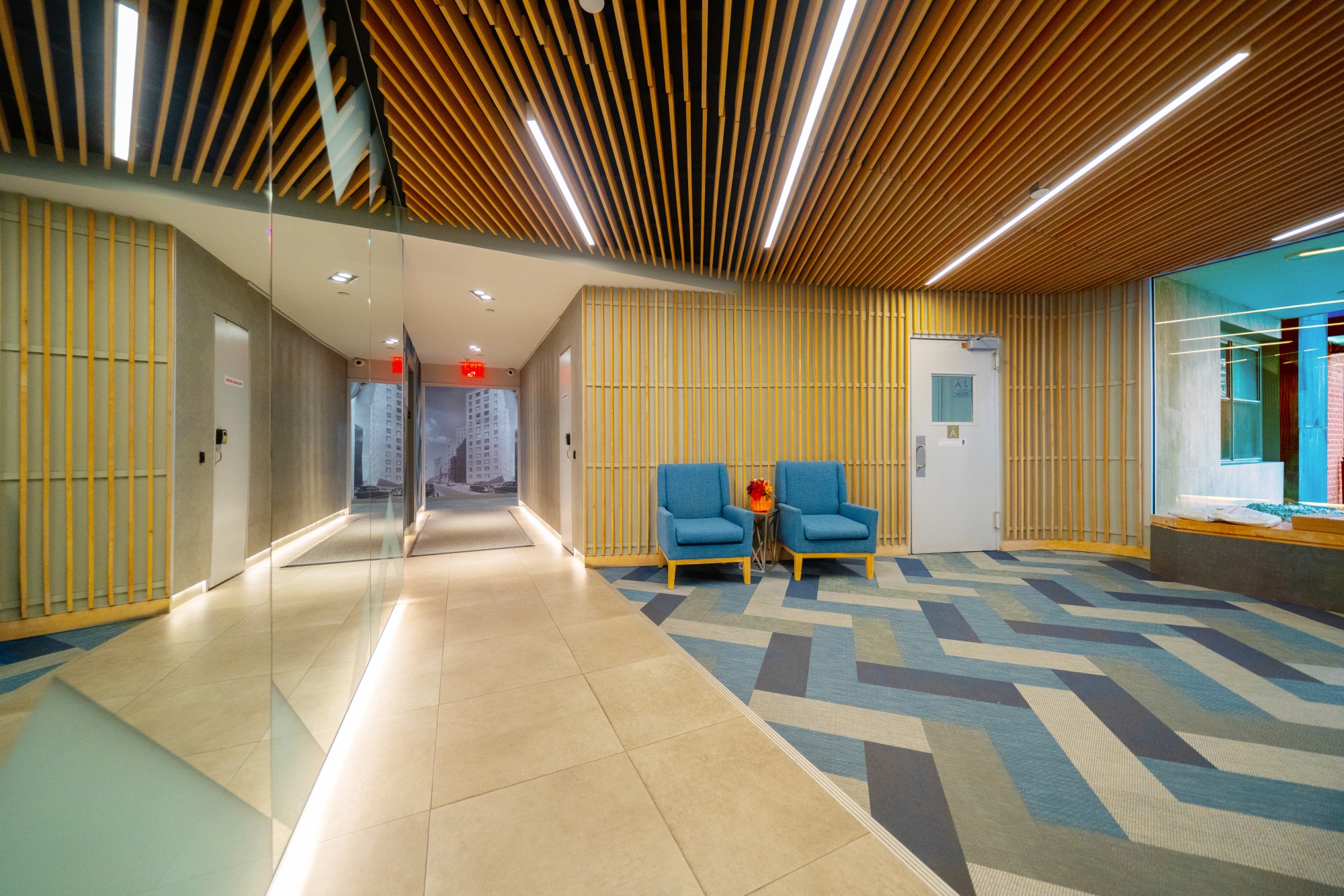99-52 66th Road, Unit 1H Queens, NY 11374 - Photo 8 of 11 a lobby with furniture and a rug