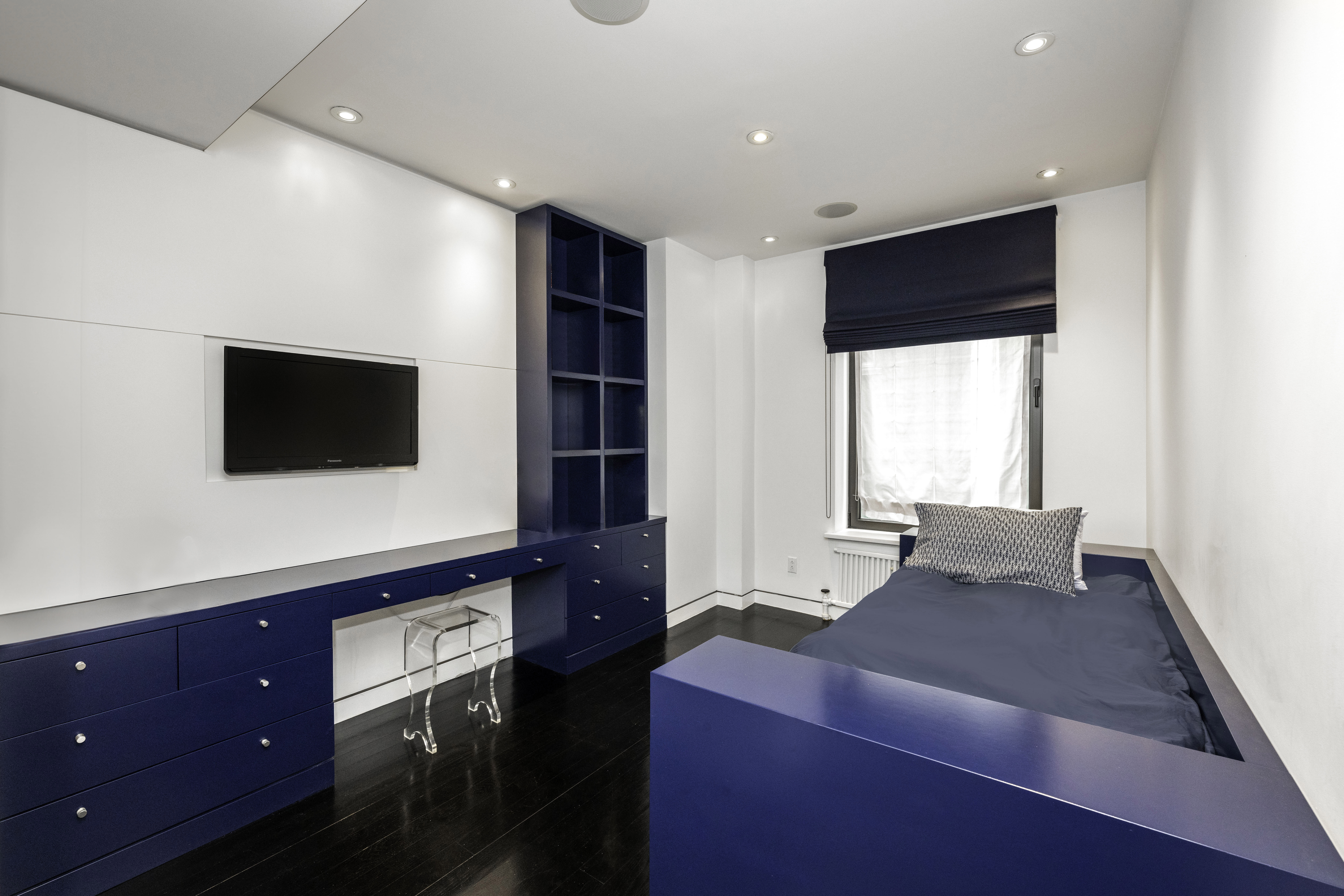 40 East 62nd Street, Unit 8E Manhattan, NY 10065 - Photo 17 of 24 a living room with furniture and a flat screen tv