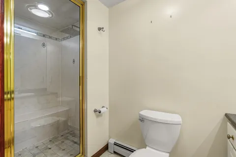 a bathroom with a toilet and shower