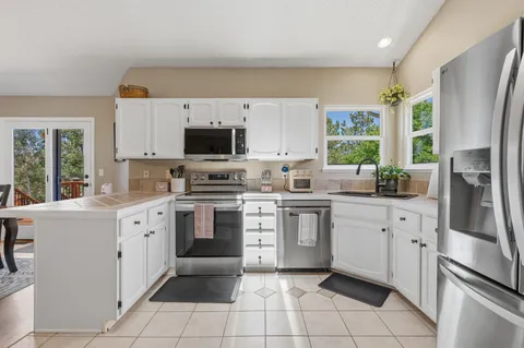 a kitchen with a sink stove and cabinets