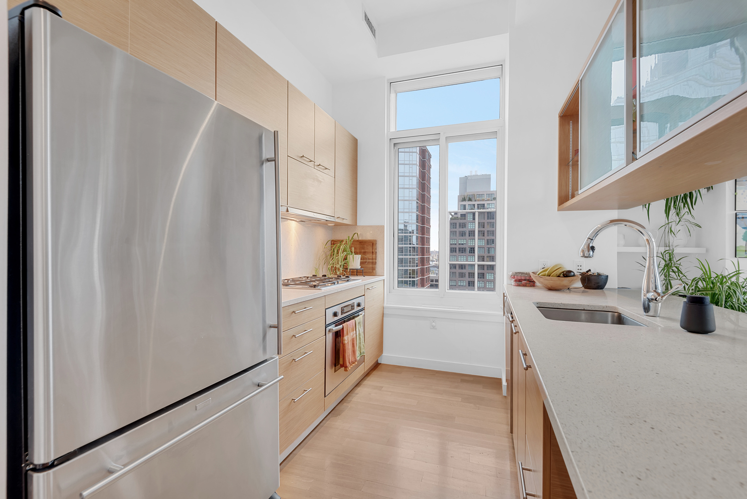 85 Adams Street, Unit 15D Brooklyn, NY 11201 - Photo 6 of 8 a kitchen with stainless steel appliances a refrigerator sink and cabinets