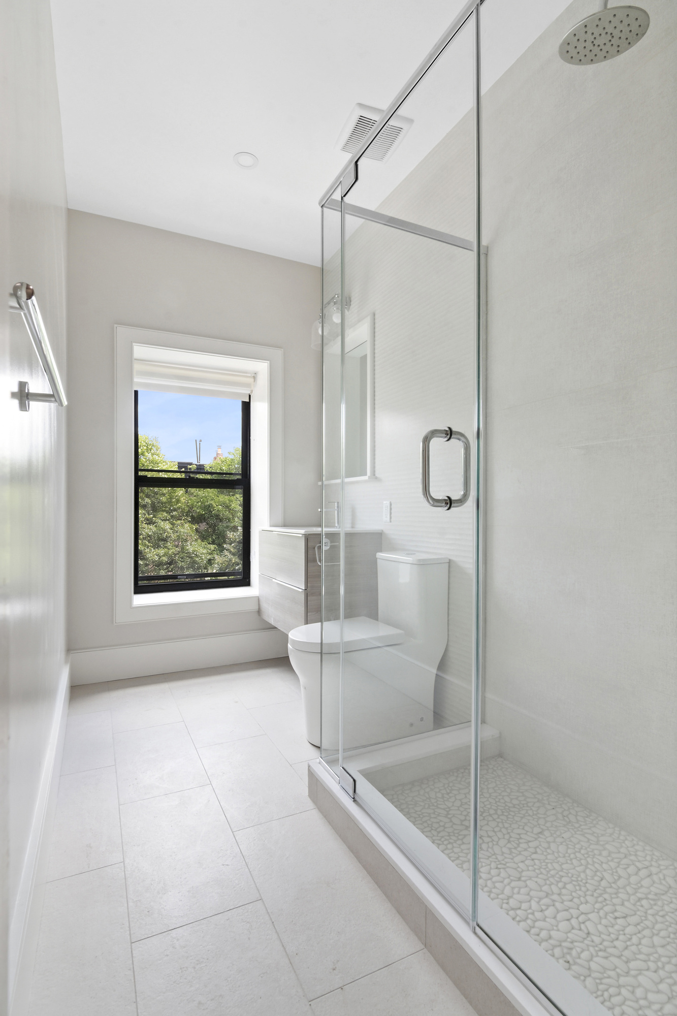 264 Stuyvesant Avenue, Unit 3 Brooklyn, NY 11221 - Photo 4 of 8 a bathroom with a glass shower door and a window