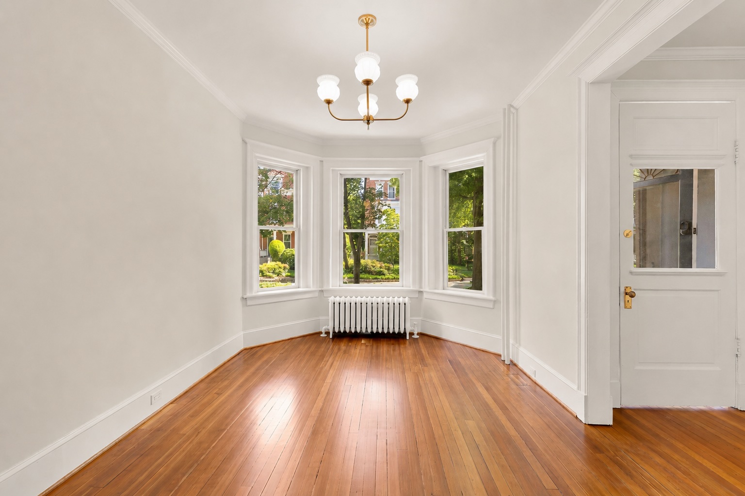1737 Park Road Northwest Washington, DC 20010 - Photo 2 of 32 a view of an empty room with wooden floor and a window