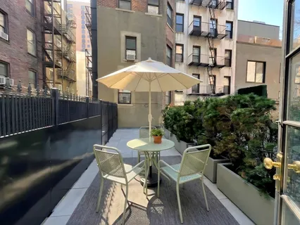 a patio with table and chairs