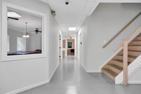 a view of a hallway view with wooden floor and furniture