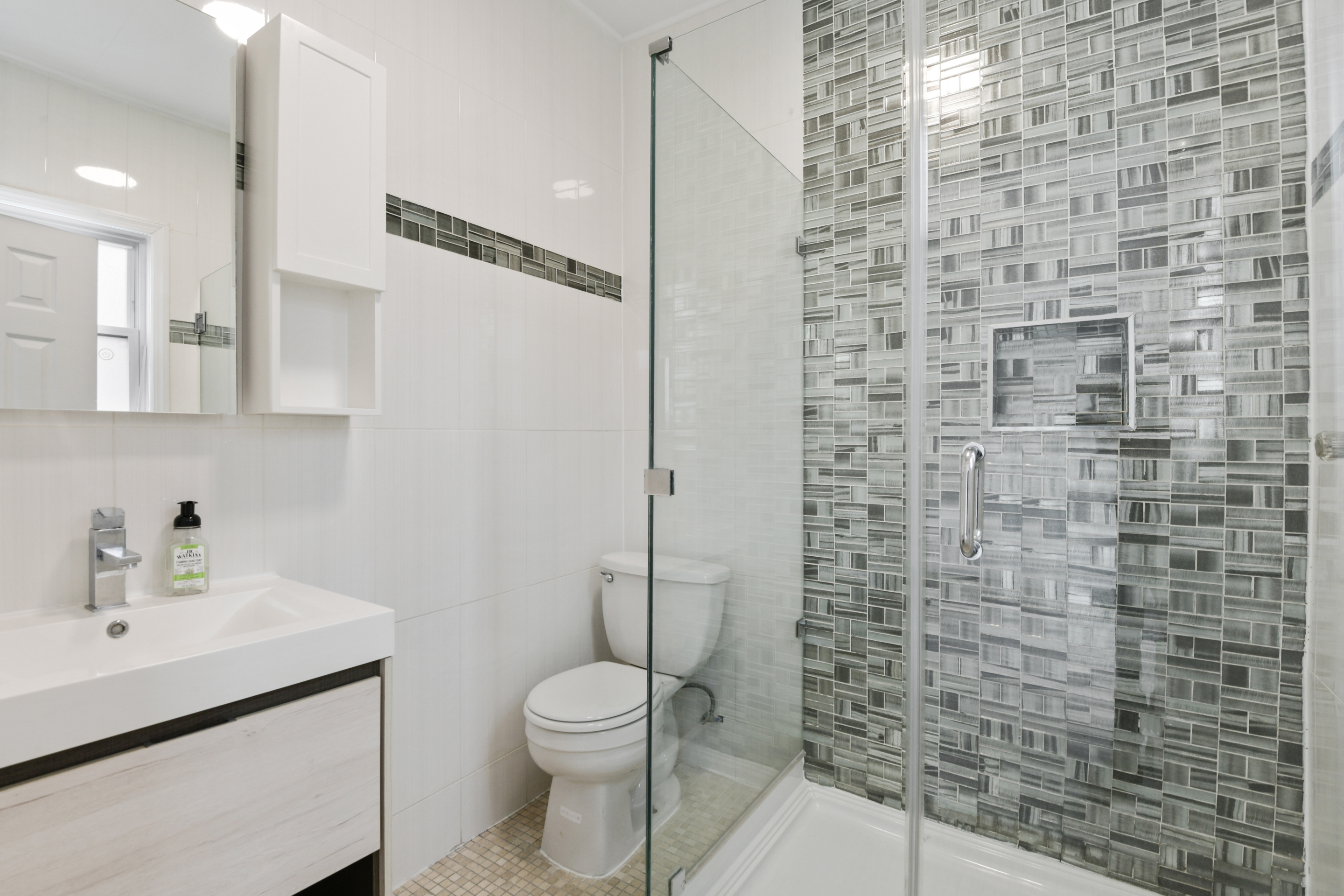 332 East 198th Street, Unit 2 Bronx, NY 10458 - Photo 8 of 10 a bathroom with a toilet sink and shower