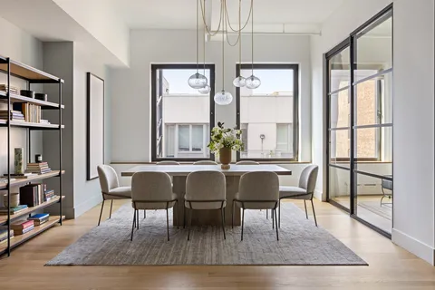 a view of a dining room with furniture and wooden floor