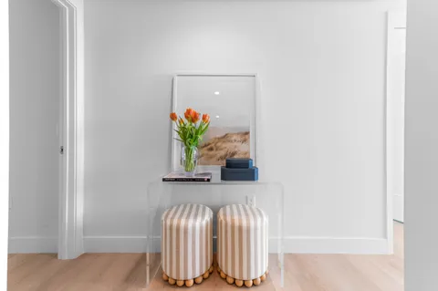 a kitchen with a table chairs refrigerator and cabinets