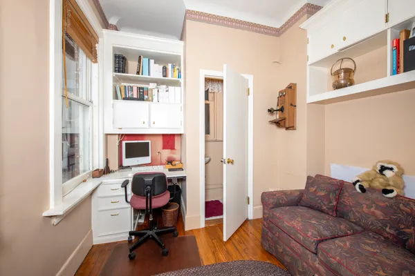 a living room with furniture gym equipment and a window