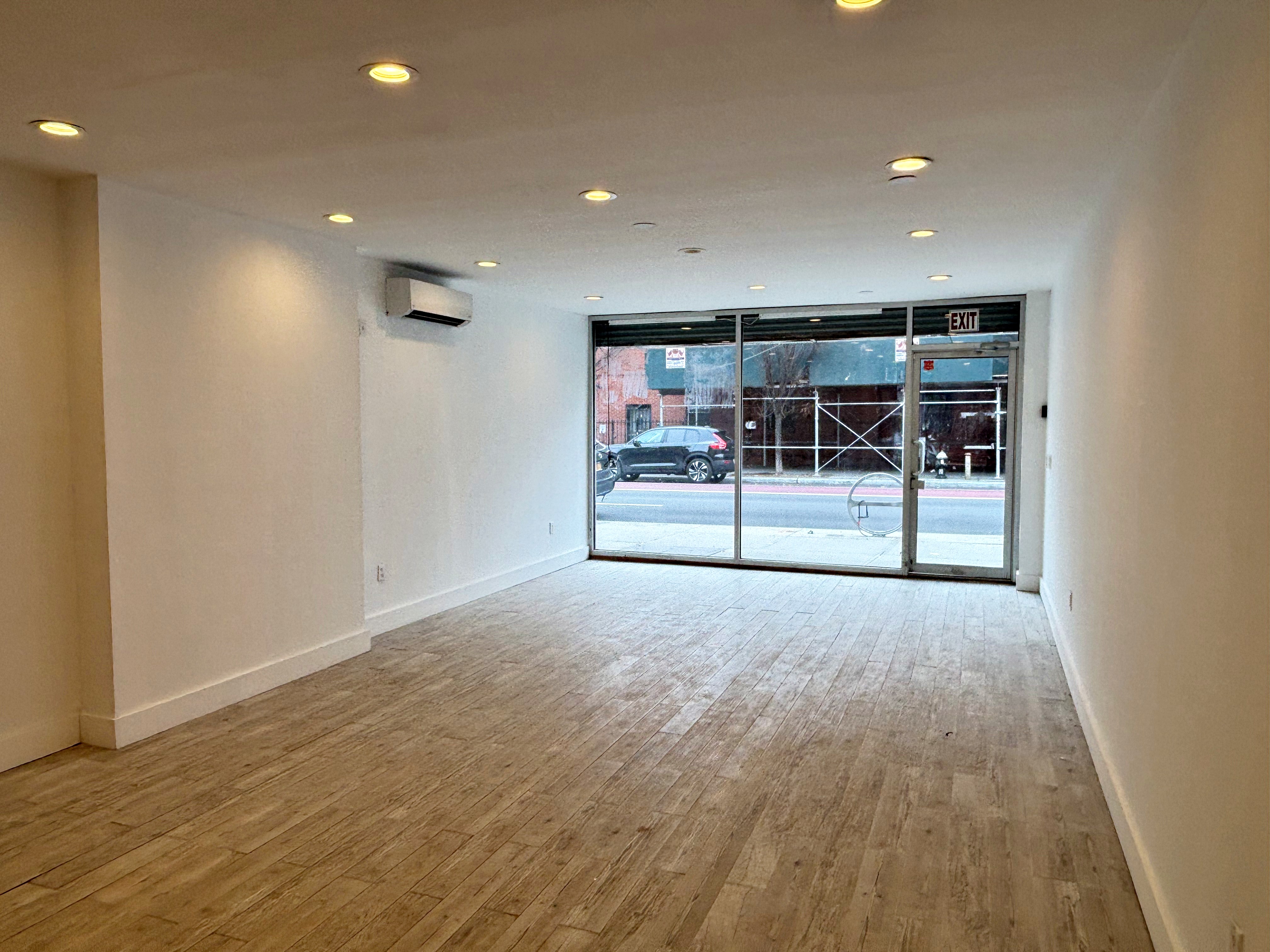 385 Nostrand Avenue, Unit Undisclosed Brooklyn, NY 11216 - Photo 5 of 27 an empty room with wooden floor and a sink