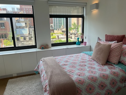 124 East 79th Street, Unit 7D Manhattan, NY 10075 - Photo 25 of 26 a bed sitting in a bedroom next to a window