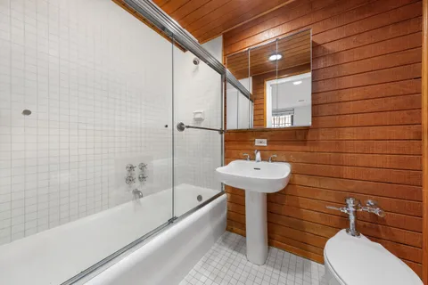 a bathroom with a sink a toilet and bathtub