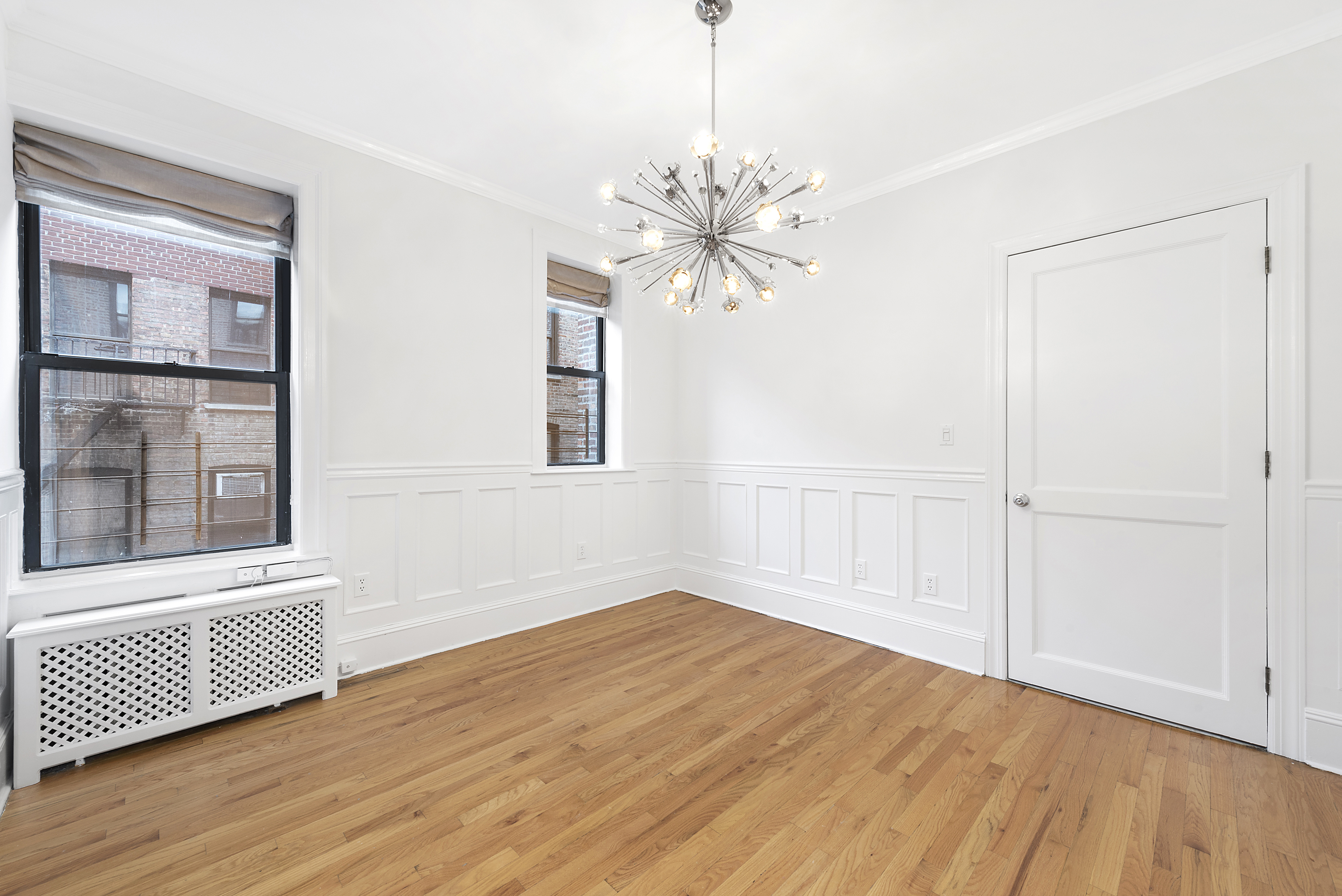 1240 Park Avenue, Unit 4D Manhattan, NY 10128 - Photo 5 of 9 a view of a room with wooden floor and a ceiling fan