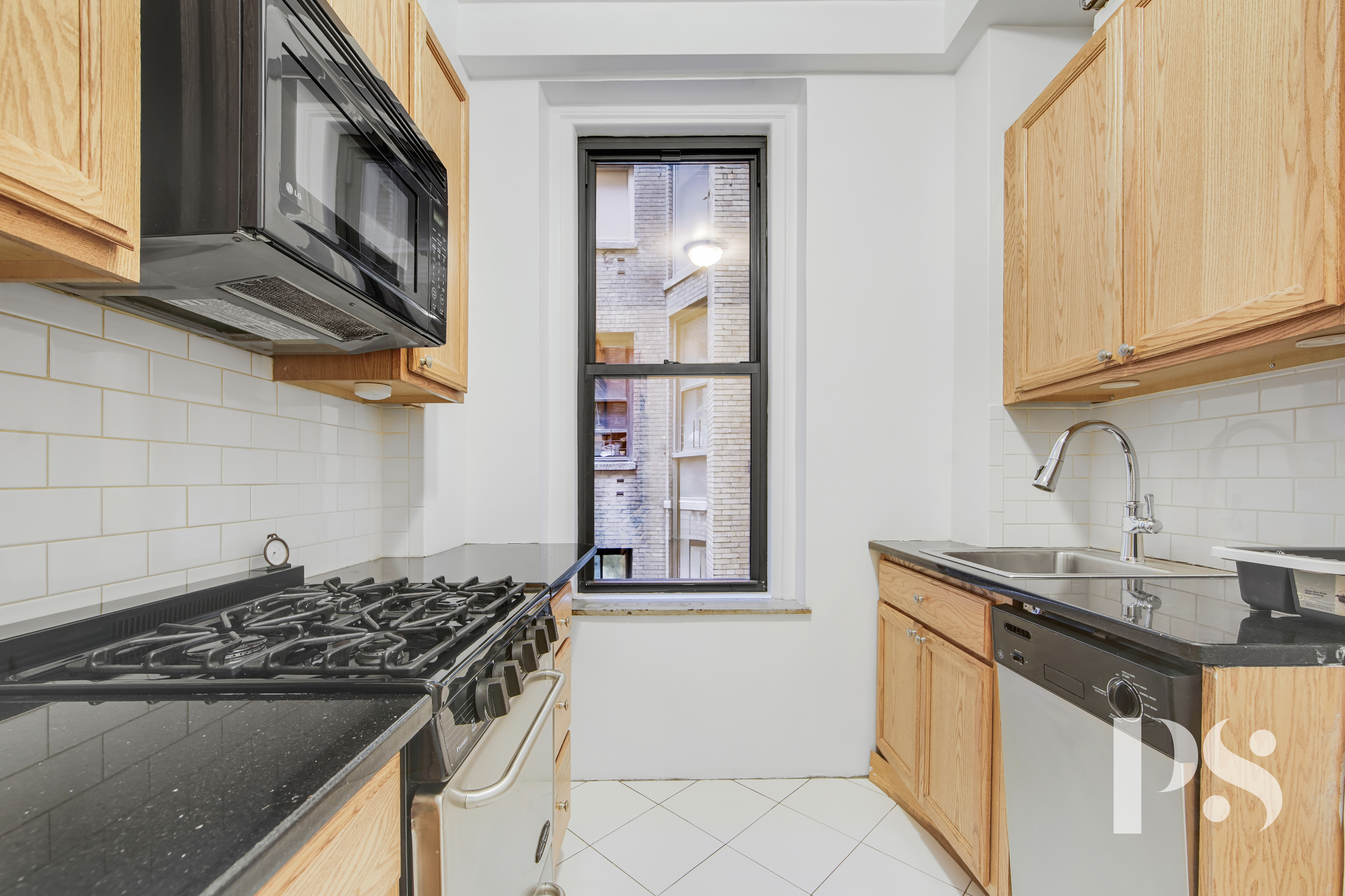 200 West 54th Street, Unit 6J Manhattan, NY 10019 - Photo 3 of 12 a kitchen with stainless steel appliances granite countertop a stove and a sink