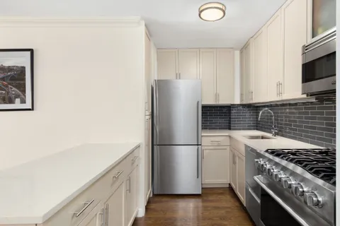 a kitchen with a refrigerator and a stove