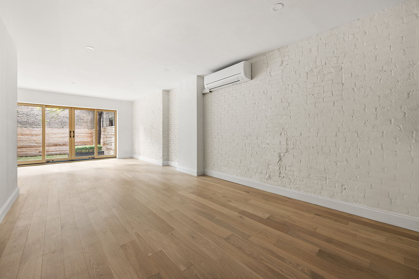 84 6th Avenue, Unit 1 Brooklyn, NY 11217 - Photo 6 of 22 a view of an empty room with wooden floor and a window