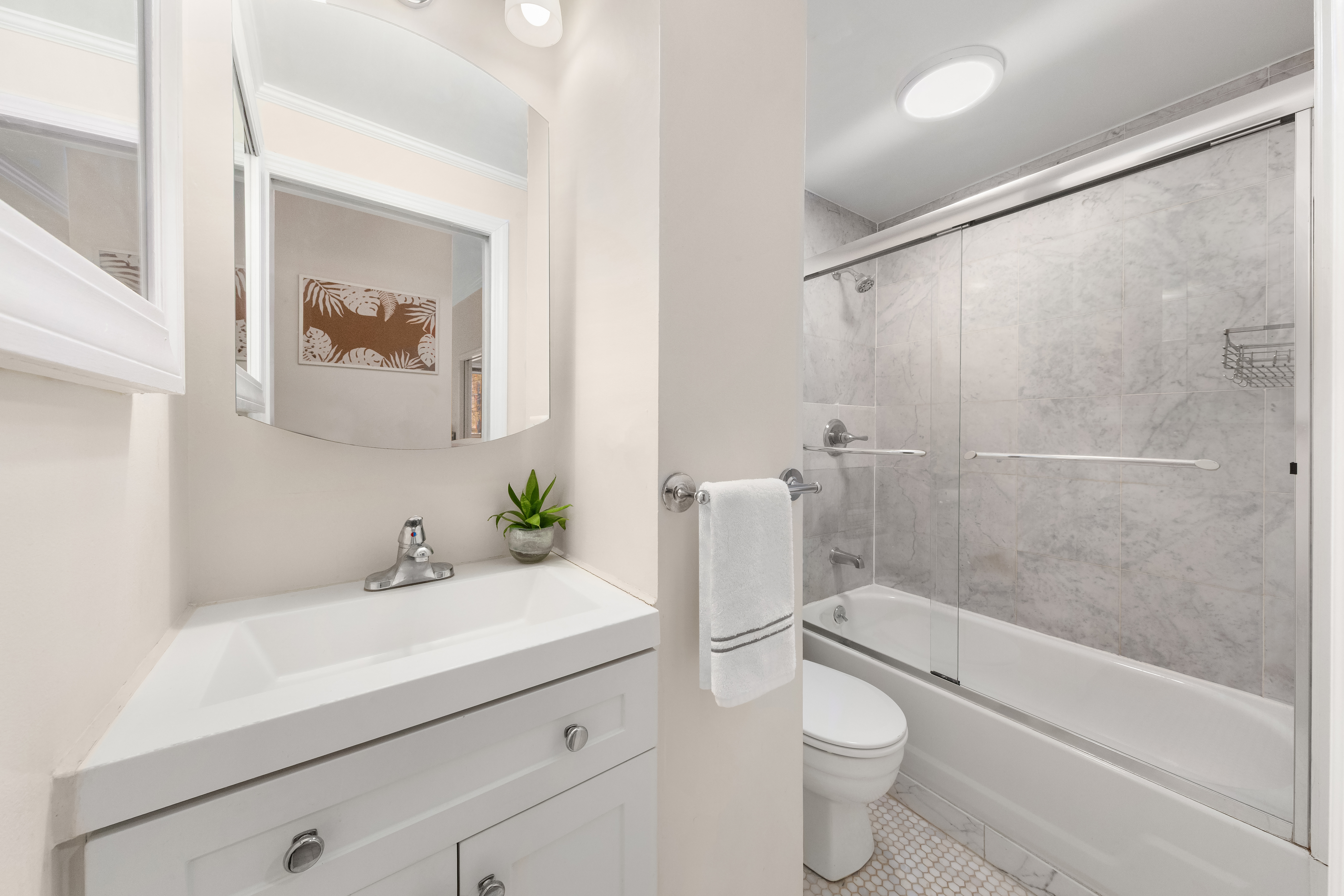 207 East 21st Street, Unit 5B Manhattan, NY 10010 - Photo 6 of 7 a bathroom with a sink a toilet and shower
