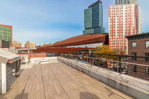 a view of balcony with furniture and city view