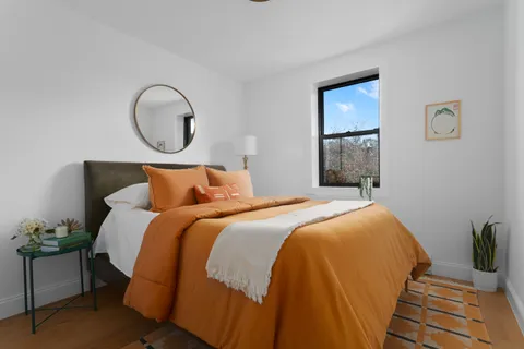 a bedroom with bed and a window