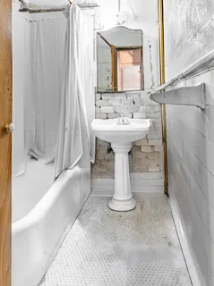 a view of a bathroom with a sink and mirror