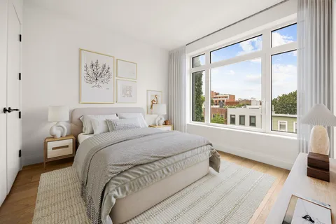 a spacious bedroom with a bed and a large window