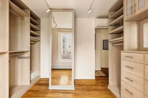 a view of walk in closet with empty racks
