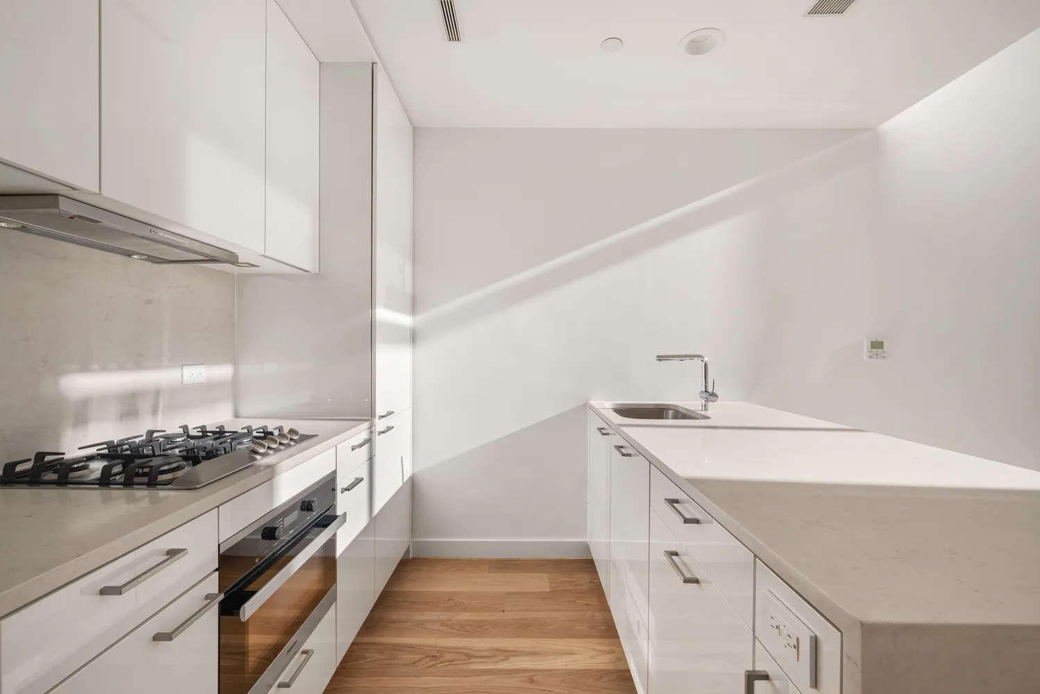 a kitchen with stainless steel appliances a sink and stove