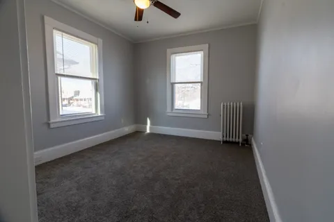 an empty room with an entryway and closet
