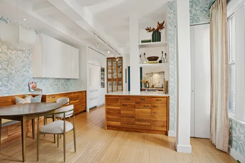 a living room with furniture a flat screen tv and a couch