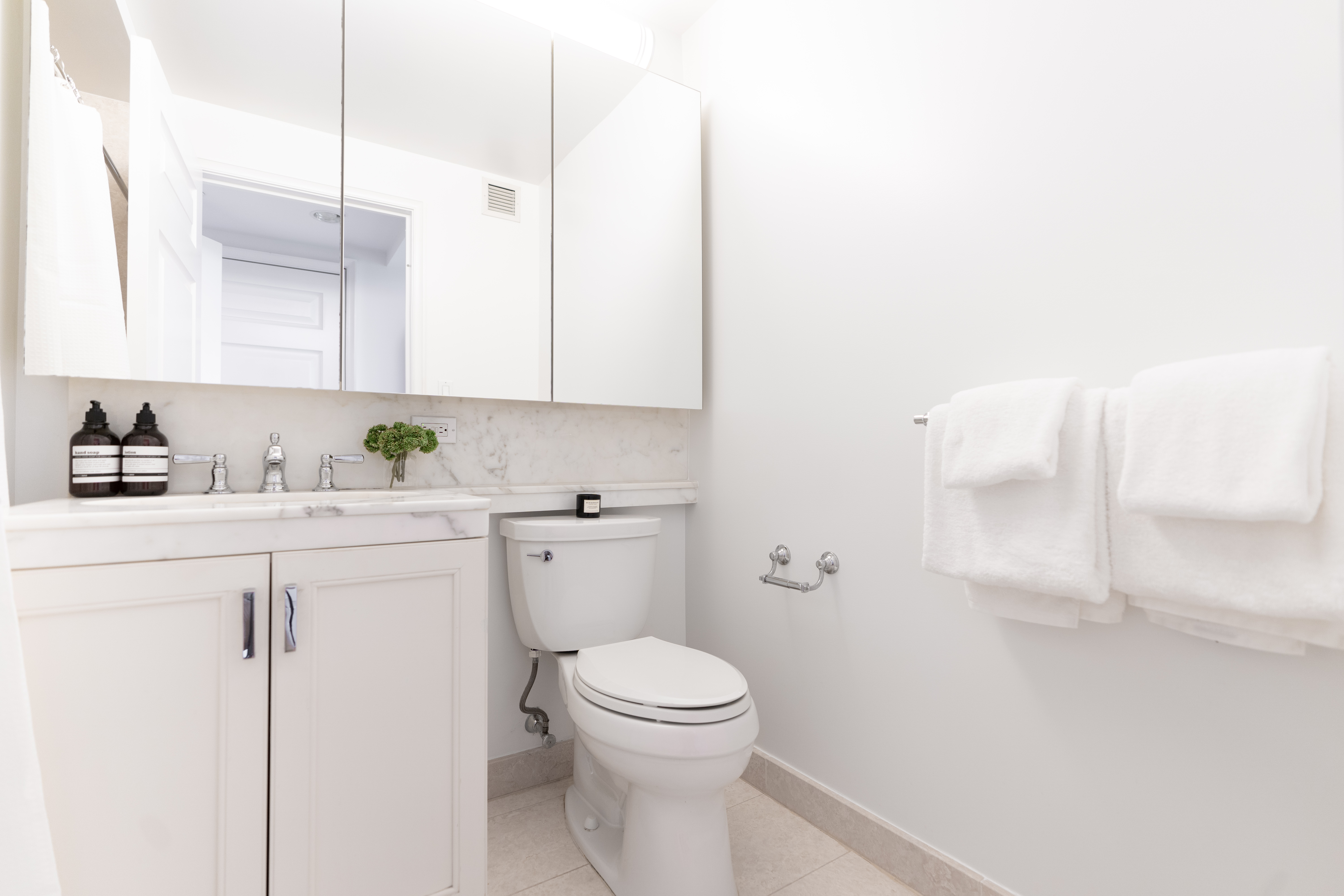 205 East 85th Street, Unit G10 Manhattan, NY 10028 - Photo 19 of 27 a bathroom with a granite countertop toilet and a sink