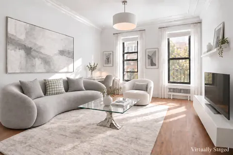 a living room with furniture a flat screen tv and wooden floor